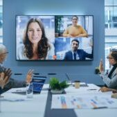 Video Conference Call in Office Boardroom Meeting Room: Executive Directors Talk with Group of Multi-Ethnic Entrepreneurs, Managers, Investors. Businesspeople Discuss e-Commerce Investment Strategy